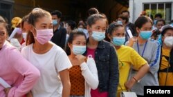 Garment factory workers and staff wait to receive China's Sinovac coronavirus disease (COVID-19) vaccine at an industrial park in Phnom Penh, Cambodia, April 7, 2021. REUTERS/Cindy Liu