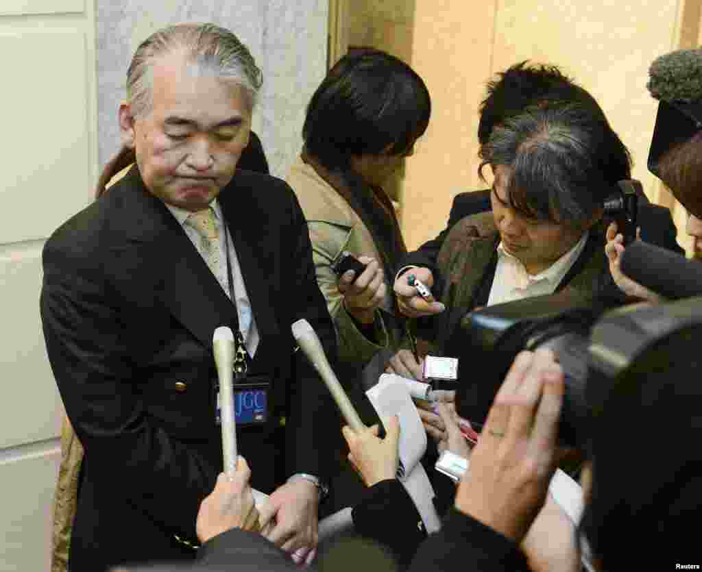 A Public Relations staff of JGC Corp answers reporters' questions regarding Japanese nationals who were kidnapped in Algeria, at its headquarters in Yokohama, south of Tokyo in this photo taken by Kyodo January 16, 2013.