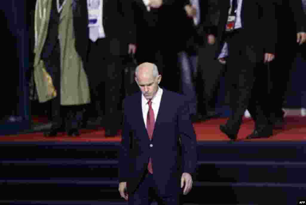 Greek Prime Minister George Papandreou leaves a G20 summit in Cannes, France on Wednesday, Nov. 2, 2011. Greek Prime Minister George Papandreou was flew to the chic French Riviera resort of Cannes on Wednesday to explain himself to European leaders furiou
