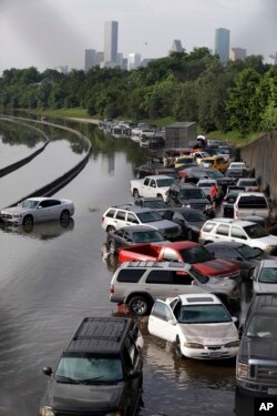 FILE- Cars remain stranded along a flooded section of Interstate 45 after heavy rains overnight in Houston, May 26, 2016. Flooding caused by heavy rains in and around Houston in the past month has killed nearly a dozen people.