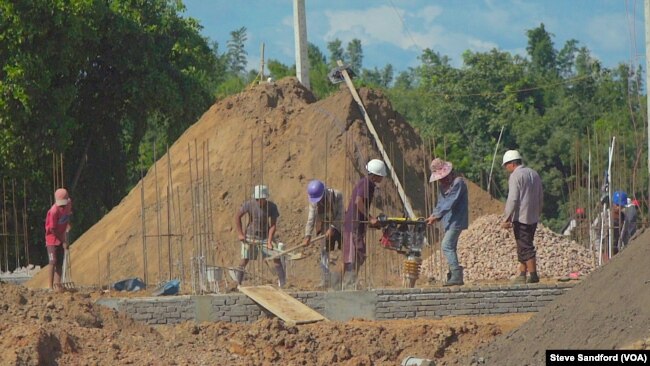 Construction workers building a condominium at the site of the Chinese resort town on the outskirts of Shwe Koko in Karen state, Myanmar.