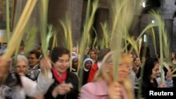 Christian worshippers hold palm fronds during the Palm Sunday procession in the Church of the Holy Sepulchre in Jerusalem's Old City, April 13, 2014.