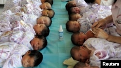 Newly born babies receive vaccines at a hospital in Aksu, Xinjiang Uighur Autonomous Region August 10, 2012. 