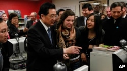 FILE - Chinese President Hu Jintao visits the Confucius Institute at Walter Payton College Preparatory High School in Chicago, Jan. 21, 2011. 
