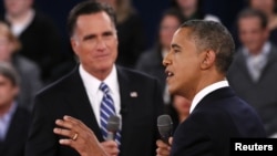 U.S. President Barack Obama (R) speaks as Republican presidential nominee Mitt Romney (L) listens during the second U.S. presidential debate in Hempstead, New York, October 16, 2012. 