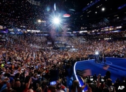 FILE - President Barack Obama, first lady Michelle Obama, their children Malia and Sasha, and Vice President Joe Biden and his wife Jill Biden, wave on stage on the final day of the Democratic National Convention in Charlotte, N.C., Sept. 6, 2012.