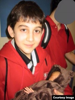 Dzhokhar Tsarnaev, shown in January 2007, holding the daughter of his grade school teacher