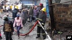 Rescuers at the scene of the pipeline explosion in Nairobi's Mukuru Sinai slums on Sept. 12, 2011.