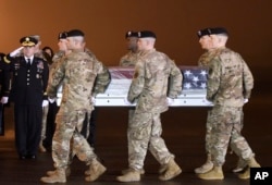 Army Chief of Staff Gen. Mark A. Milley, left, salutes as an Army carry team moves a transfer case containing the remains of Maj. Brent R. Taylor at Dover Air Force Base, Del., on Tuesday, Nov. 6, 2018.