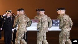 Army Chief of Staff Gen. Mark A. Milley, left, salutes as an Army carry team moves a transfer case containing the remains of Maj. Brent R. Taylor at Dover Air Force Base, Del., on Tuesday, Nov. 6, 2018.