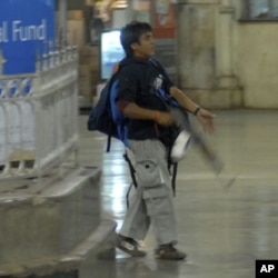 Pakistani Mohammed Ajmal Kasab walks in the Chatrapathi Sivaji Terminal railway station during the 2008 attacks in Mumbai. Kasab, the only surviving gunman, was convicted this month by an Indian court.