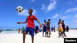 De jeunes somaliens jouent au football sur la plage de Lido, à Mogadiscio, le 8 août 2013.