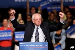 Democratic presidential candidate Sen. Bernie Sanders of Vermont acknowledges his supporters upon his arrival at a campaign rally in Miami, March 8, 2016.