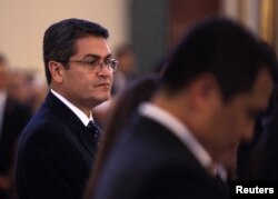 Honduras President Juan Orlando Hernandez looks on during a funeral mass for his late sister Hilda Hernandez in Tegucigalpa, Dec. 18, 2017.