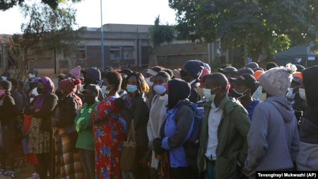 People wait in a queue to be vaccinated at a government hospital in Harare, Zimbabwe on Friday, Sept, 17, 2021. (AP Photo/Tsvangirayi Mukwazhi)