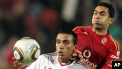 El Zamalek's Mohamed Abdel-Shafy (L) fights for the ball with Al-Ahly's Ahmed Fathy during their Egyptian Premier League derby soccer match at Cairo Stadium, (File)