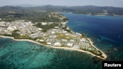 FILE - Coral reefs are seen along the coast near the U.S. Marine base Camp Schwab, off the tiny hamlet of Henoko in Nago on the southern Japanese island of Okinawa, in this aerial photo taken by Kyodo, Oct. 29, 2015.