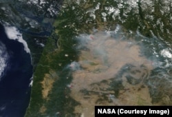 NASA's Terra satellite shows a blanket of smoke from several raging fires in western and central Washington state, Aug. 17.