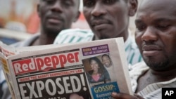A Ugandan reads a copy of the "Red Pepper" tabloid newspaper in Kampala, Uganda, Feb. 25, 2014.
