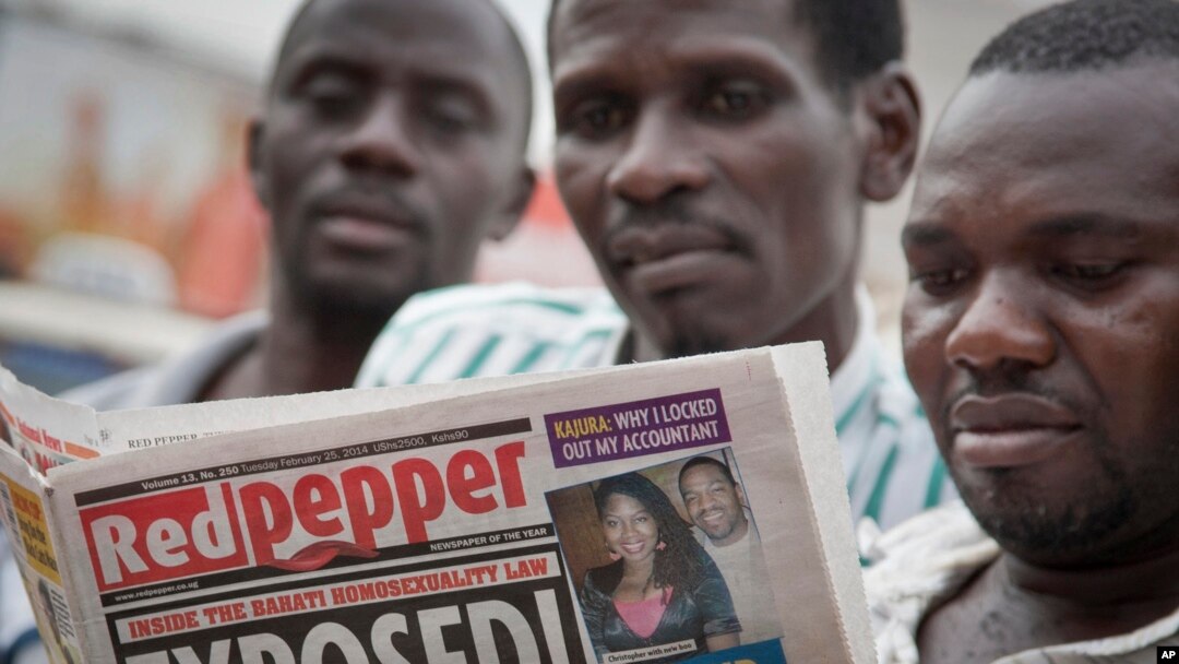A Ugandan reads a copy of the "Red Pepper" tabloid newspaper in Kampala, Feb. 25, 2014.