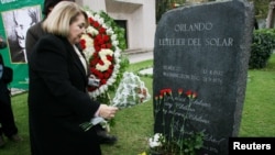 Isabel Morel, the widow of Orlando Letelier, a former Foreign Minister of Salvador Allende Government, who was killed when his car exploded 30 years ago in Washington in 1976, puts flowers on Letelier's grave in Santiago, Sept. 21, 2006. 