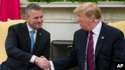 President Donald Trump shakes hands with Slovak Prime Minister Peter Pellegrini during a meeting in the Oval Office of the White House, May 3, 2019, in Washington.