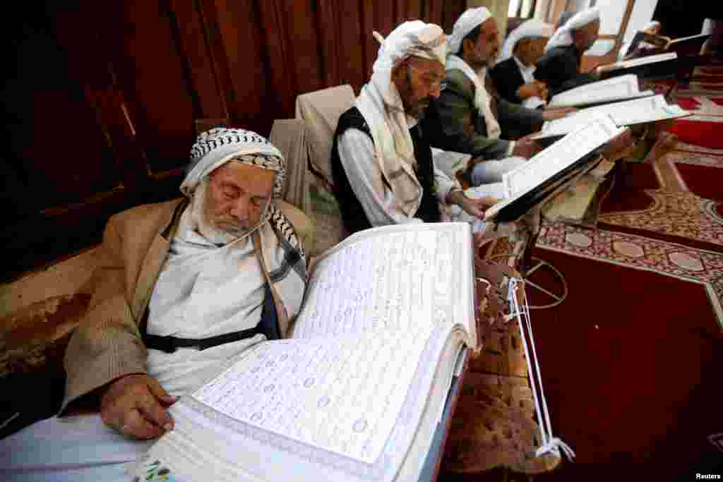 A man rests while reading the Koran at the Grand Mosque, during the holy month of Ramadan, in Sana'a, Yemen.