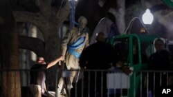 A statue of Confederate Gen. Robert E. Lee is removed from the University of Texas campus, Aug. 21, 2017, in Austin, Texas.