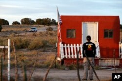 A law enforcement vehicle leaves the Bonanza Creek Film Ranch in Santa Fe, N.M. Friday, Oct. 22, 2021. Actor Alec Baldwin fired a prop gun on the set of a Western being filmed at the ranch on Thursday, Oct. 21, killing the cinematographer, officials said.