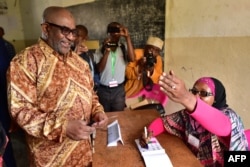 FILE - Comoros' President Azali Assoumani arrives at a polling station to cast his ballot during a constitutional referendum, July 30, 2018.