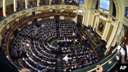 Members of Egypt's Parliament attend the inaugural session, the first to convene in three years, in Cairo, Jan. 10, 2016. 