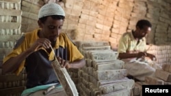 Men prepare bars of salt to be sold in the main market of the city of Mekele, northern Ethiopia, in this April 24, 2013, file photo.