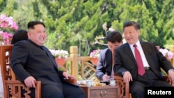 North Korean leader Kim Jong Un meets with China's President Xi Jinping, in Dalian, China in this undated photo released on May 9, 2018 by North Korea's Korean Central News Agency (KCNA).