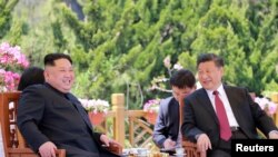 North Korean leader Kim Jong Un meets with China's President Xi Jinping, in Dalian, China in this undated photo released on May 9, 2018 by North Korea's Korean Central News Agency (KCNA).