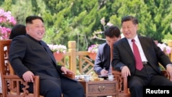 FILE - North Korean leader Kim Jong Un meets with China's President Xi Jinping, in Dalian, China in this undated photo released, May 9, 2018, by North Korea's Korean Central News Agency (KCNA).
