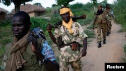 Seleka fighters patrol as they search for Anti-Balaka Christian militia members in the town of Lioto June 6, 2014. 