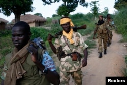 FILE - Seleka fighters patrol the town of Lioto, Central African Republic, June 6, 2014.