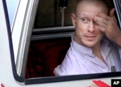 FILE - In this file image taken from video obtained from Voice Of Jihad Website, which has been authenticated based on its contents and other AP reporting, Sgt. Bowe Bergdahl, sits in a vehicle guarded by the Taliban in eastern Afghanistan.