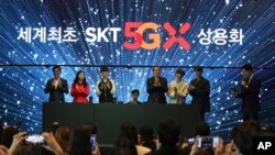 SK Telecom CEO Park Jung-ho, left, and participants attend a media showcase for the company's 5G service in Seoul, South Korea, April 3, 2019. SK Telecom will be launching commercial 5G services nationwide on Friday.