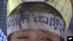 Poa Sokun Kanha, 11, from Boueng Kak cries as she joins a rally to ask King Norodom Sihamoni to help release of villagers, in front of Royal Palace in Phnom Penh, Thursday, May 31, 2012. The villagers were arrested when they tried to rebuild their homes o