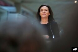 FILE - Chief Operating Officer of Facebook, Sheryl Sandberg, delivers a speech during the visit of a start-up companies in Paris, France, Jan. 17, 2017.