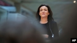 FILE - Chief Operating Officer of Facebook, Sheryl Sandberg, delivers a speech during the visit of a start-up companies in Paris, France, Jan. 17, 2017.