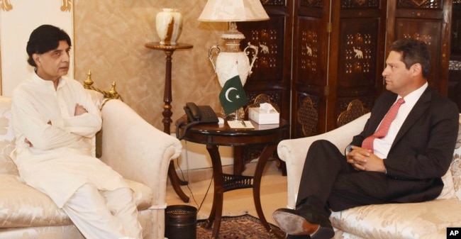 In this photo released by Pakistan's Press Information Department, July 7, 2017, Pakistani Interior Minister Chaudhry Nisar Ali Khan, left, meets Vice President of Facebook Joel Kaplan in Islamabad, Pakistan.