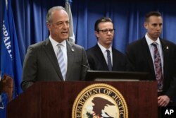 United States Attorney Nick Hanna, left, announces the latest on new federal charges against attorney Michael Avenatti during a news conference in Los Angeles, April 11, 2019.