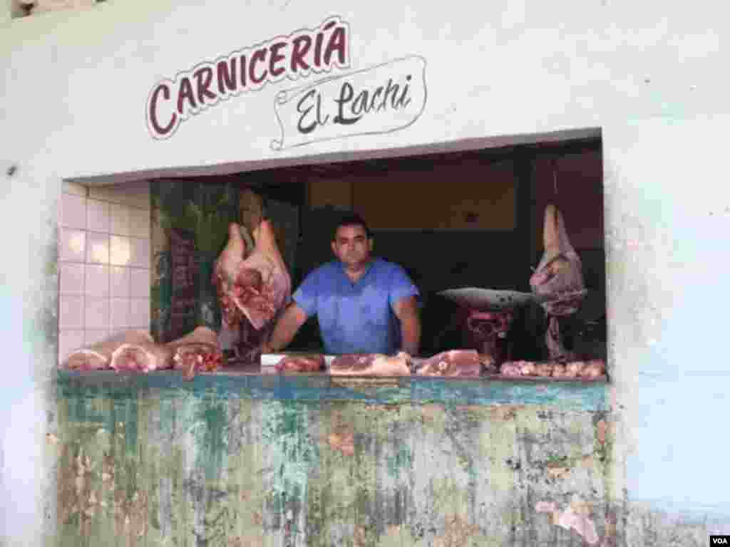 "El Pachi" has a butcher shop next to the new U.S. Embassy in Havana, where the U.S. flag-raising ceremony was to occur. But, the day was business as usual for him at his "Carnicería," Aug. 14, 2015. (Celia Mendoza/VOA)