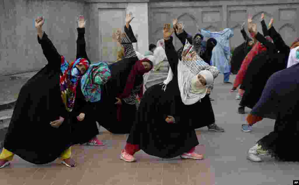 Women take part in yoga session in the historical Shalimar Garden in Lahore, Pakistan.