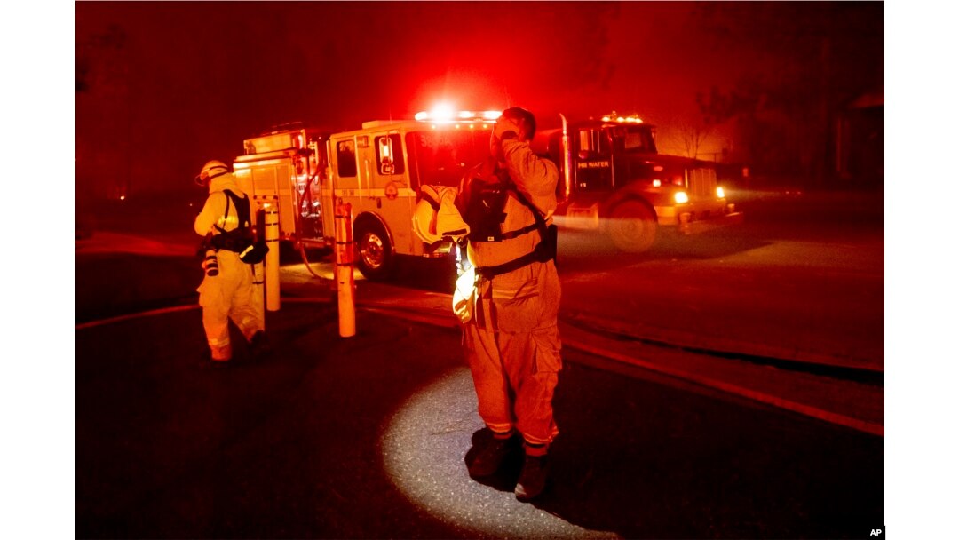 Firefighter Adrien Mahnke pauses while battling the Camp Fire as it tears through Paradise, Calif., on Nov. 8, 2018.