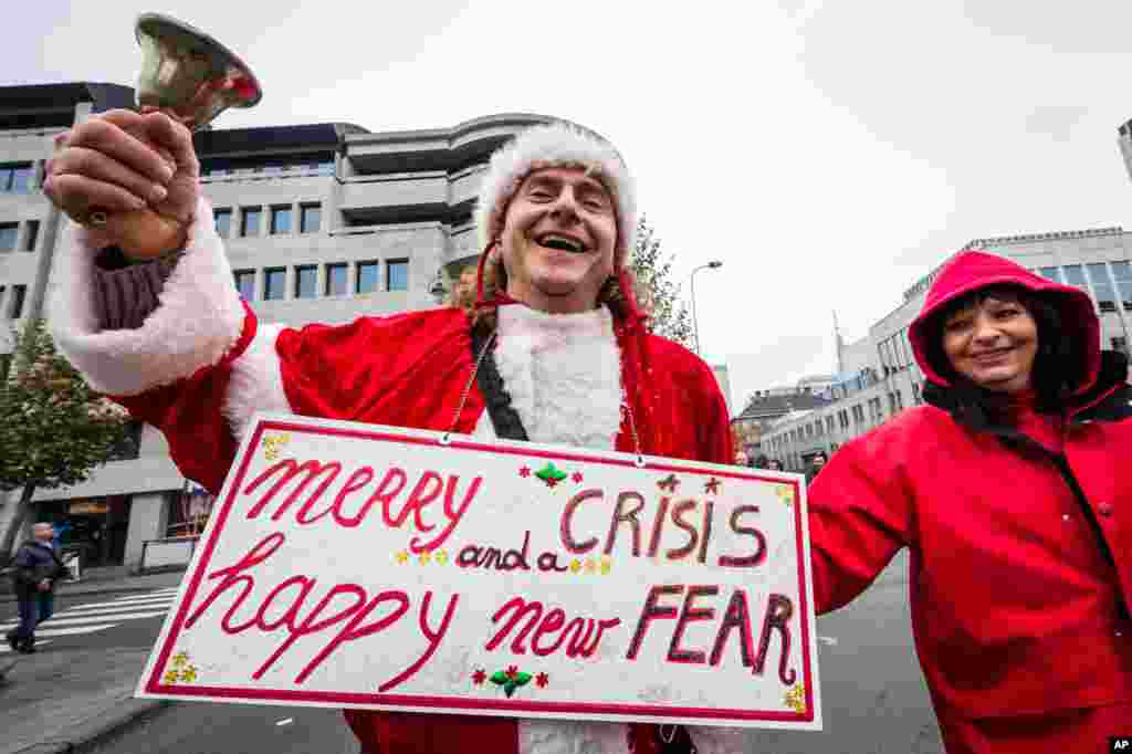 A worker dressed as Santa protests austerity measures, Brussels, Belgium, Nov. 6, 2014. 
