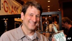 Paul Hletko, founder of FEW Spirits, holds a bottle of FEW American Gin during the American Distilling Institute's 10th Anniversary Spirits Conference and Vendor Expo on Monday, April 1, 2013, in Denver, Colorado. (Jack Dempsey/AP Images for Owens-Illin