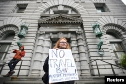 FILE - Beth Kohn protests against President Donald Trump's executive order travel ban outside the 9th U.S. Circuit Court of Appeals in San Francisco, Calif., Feb. 7, 2017.